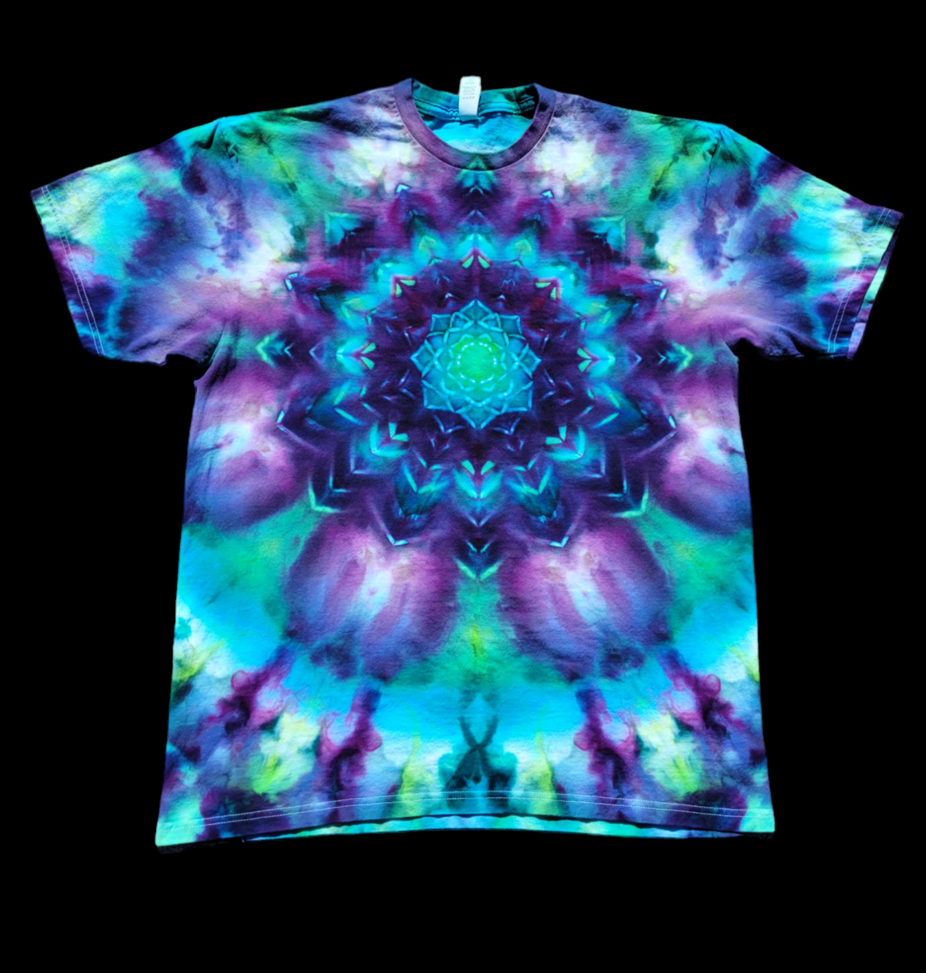 Ice-dyed tie-dye shirt in Blooming Mandala pattern. Rich blues, purples, and greens create a lotus-like pattern on crew neck shirt.