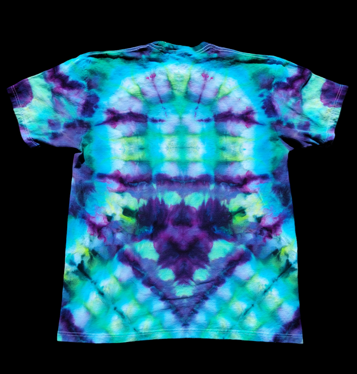 Back of blooming mandala t-shirt in purples, blues, and greens. Abstract design comes to a point in the back.