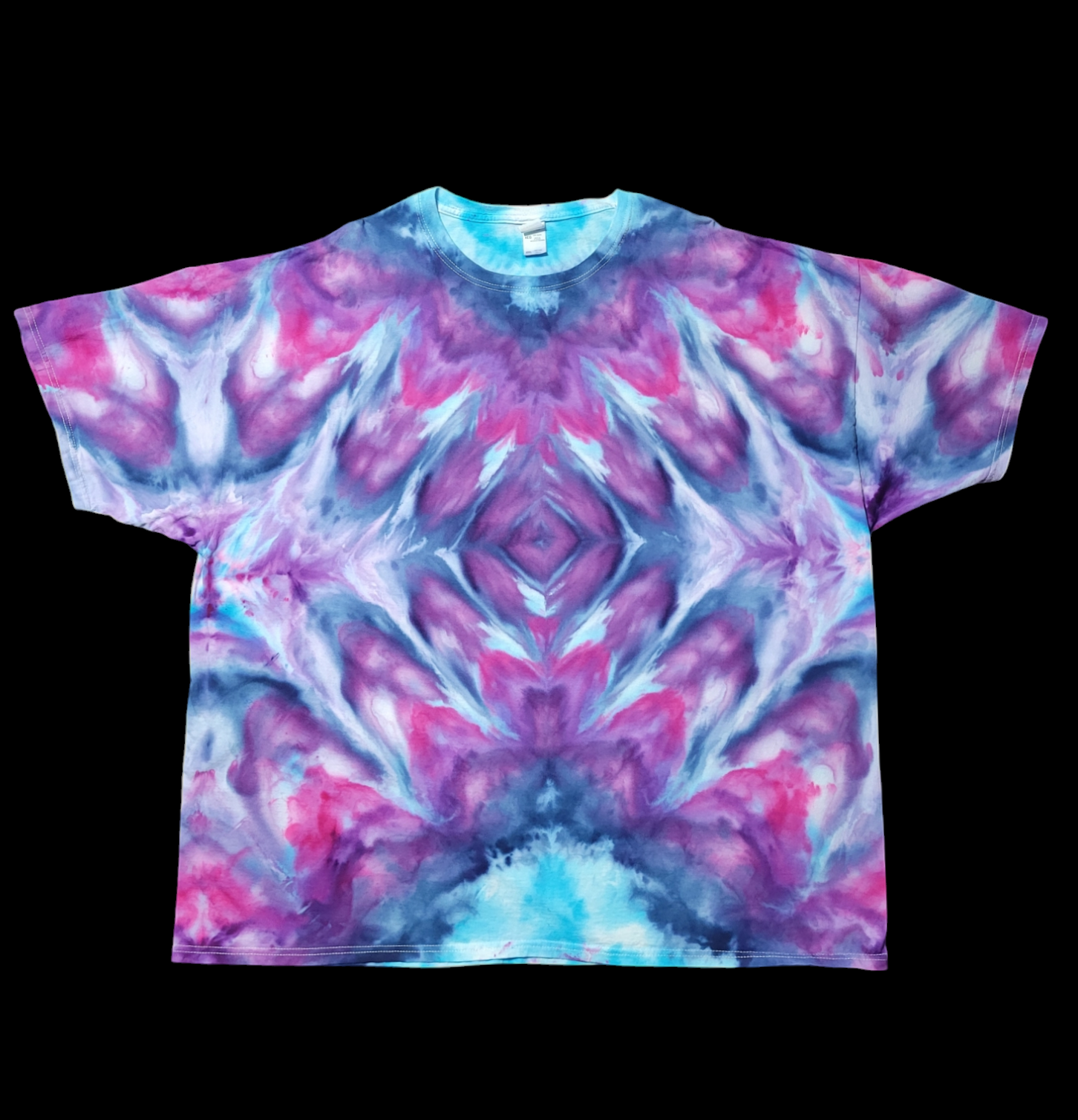 Front view of t-shirt tie-dyed in  purples and blues bursting outward from a diamond pattern in the center.