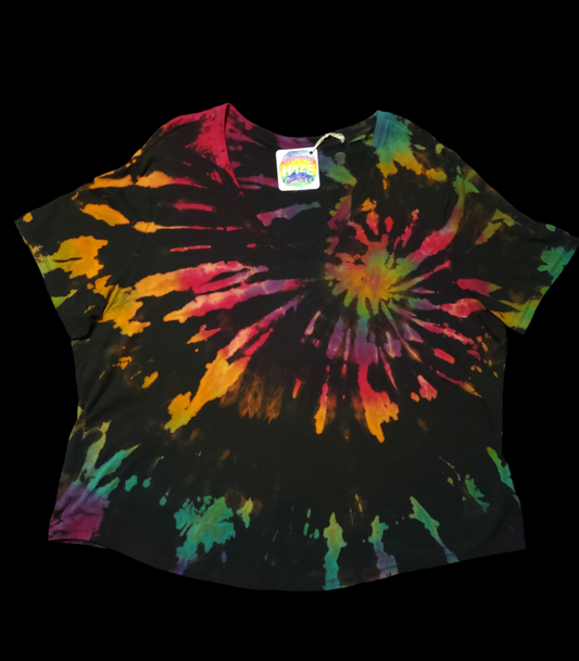 Front view of short-sleeved women's t-shirt with brilliant rainbow colors splashing out from its center on a dark background.