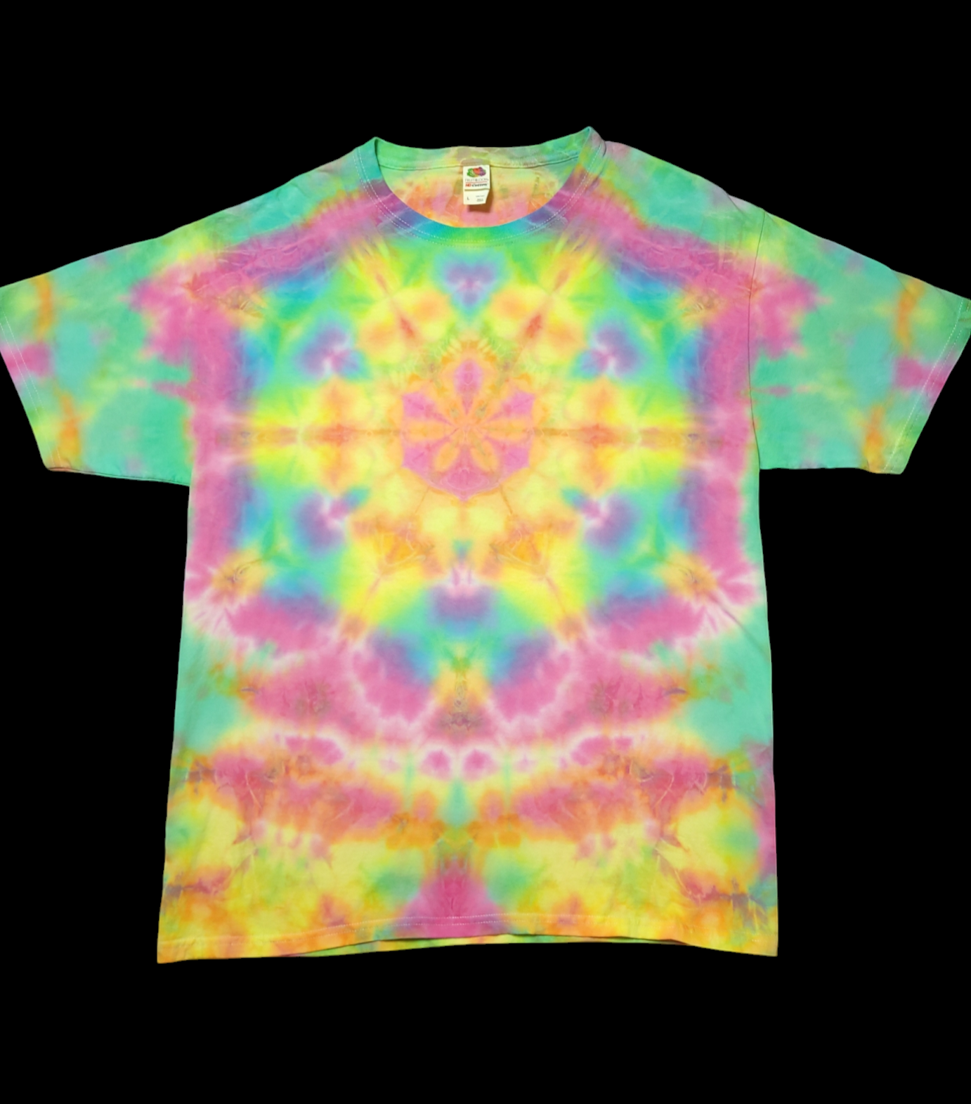 Front view of shirt with tie-dye geometric mandala in the center, in a soft rainbow of blues, greens, pinks, oranges, and yellows.