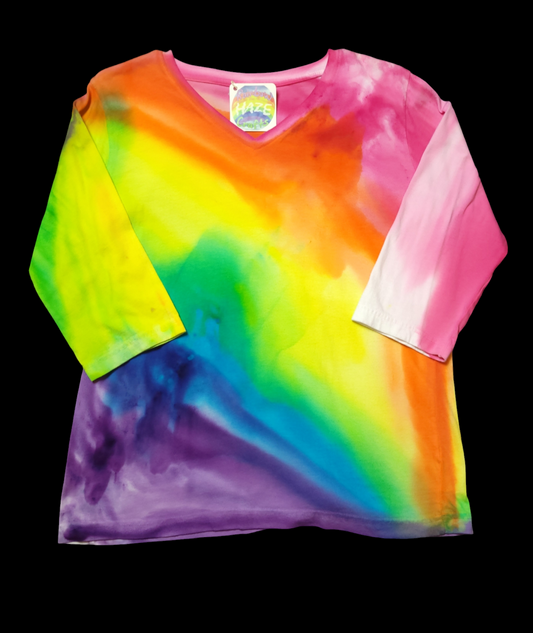 Front view with diagonal flow of rainbow colors across the t-shirt. 3/4 sleeve. V-neck