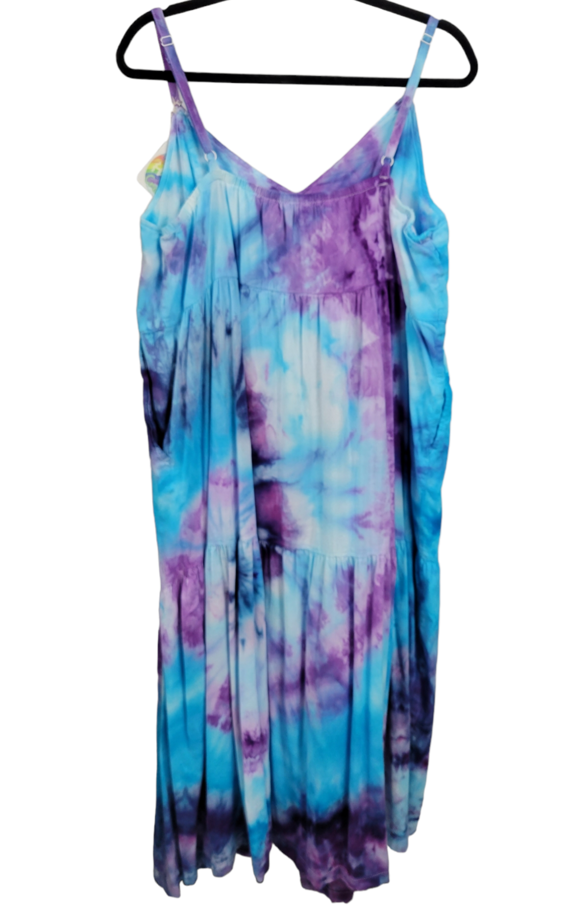 Back view of adjustable-strap dress tie-dyed in variations of purple and blue. 