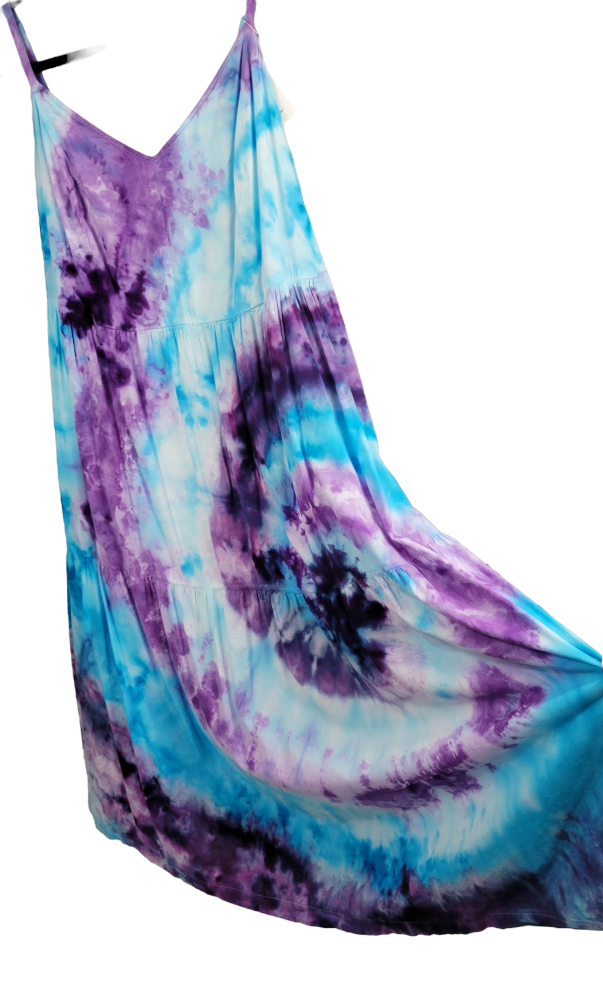 Detail view of adjustable-strap, tie-dye dress to showcase offset spiral of purple and blue on the left. 