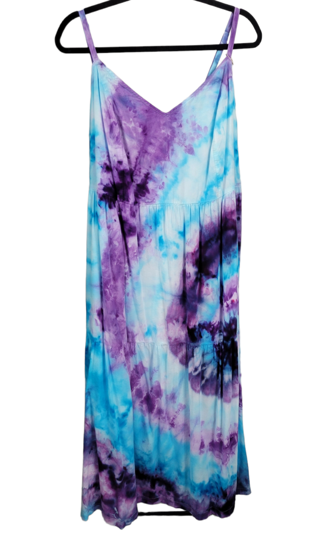 Front view of adjustable-strap, tie-dye dress in a spiral of purple and blue variations radiating from the left. 